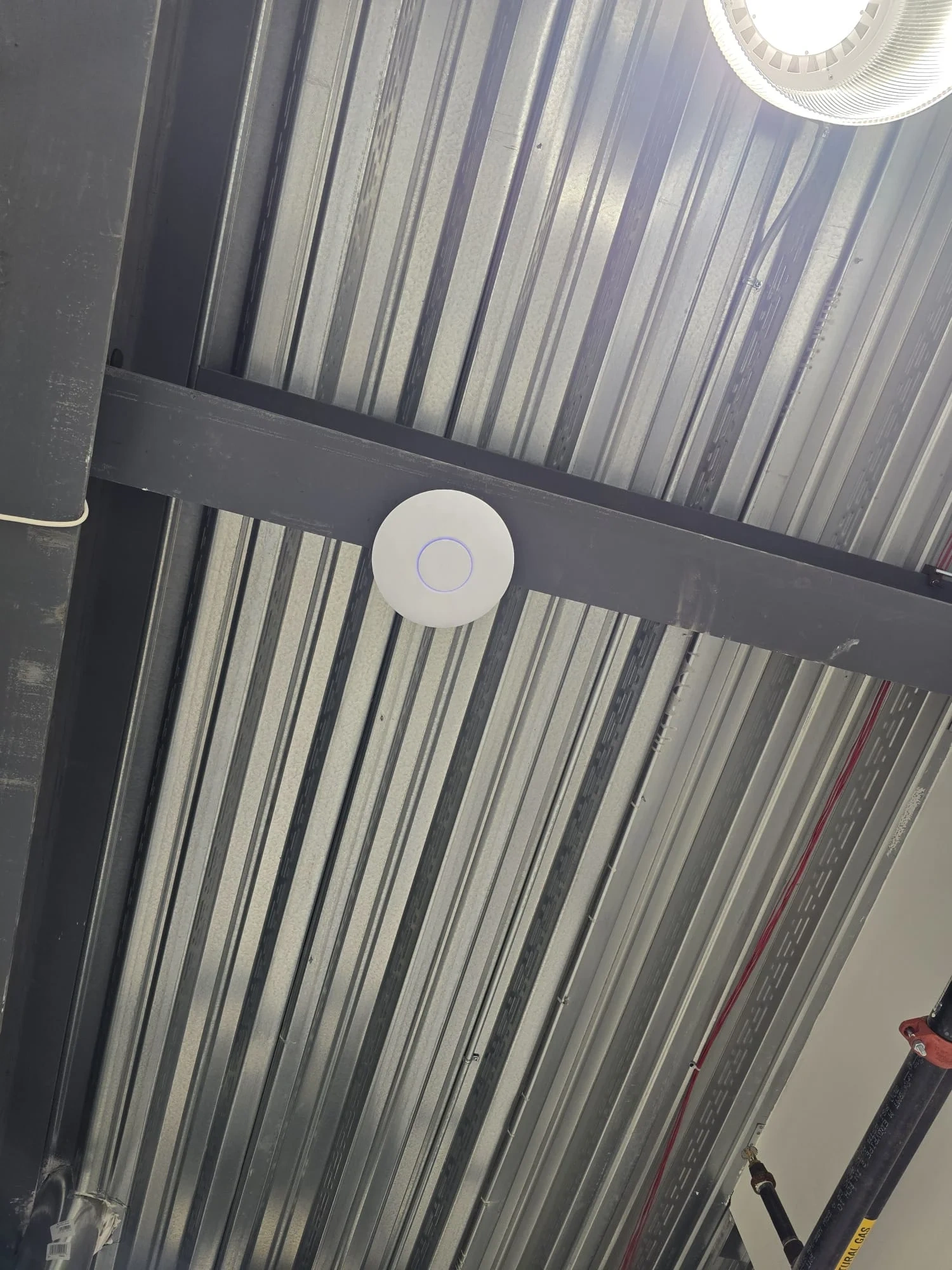 Ceiling-mounted wireless access point installed in a commercial space