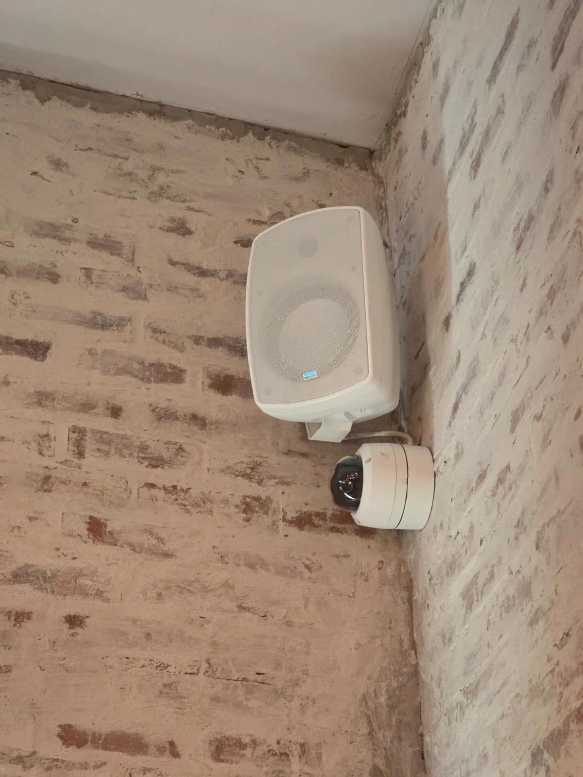 Exterior wireless access point installed on a brick building wall