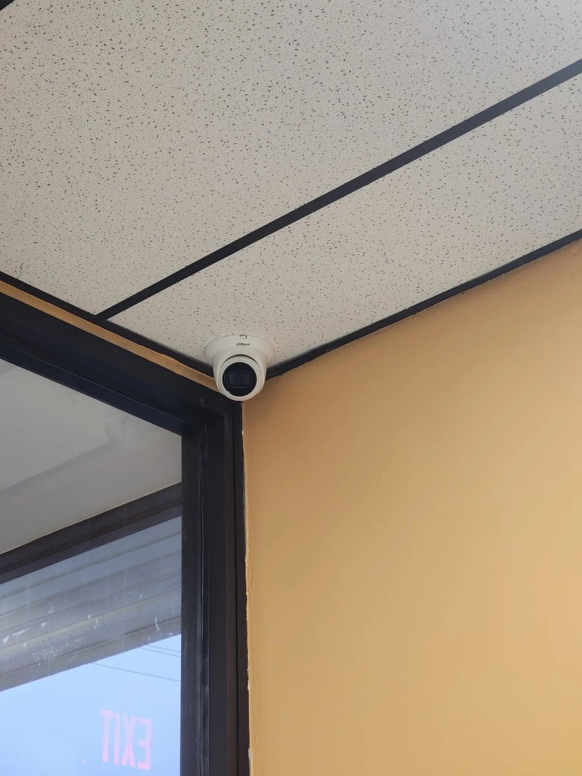 Corner-mounted security camera installed in a commercial interior